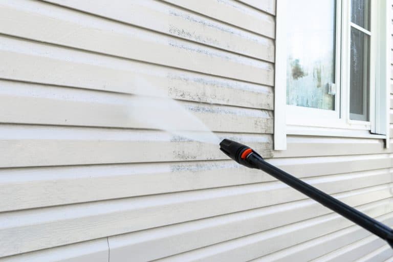 Powerwashing side of house